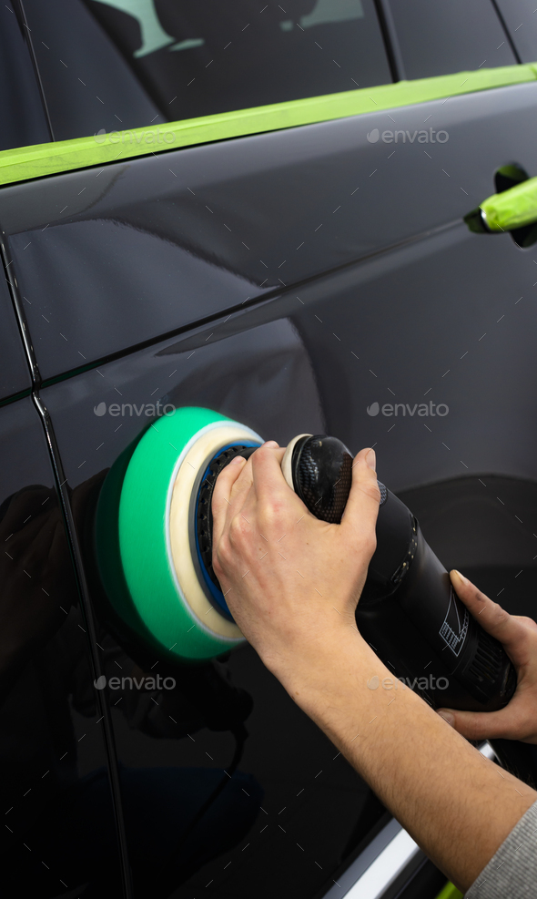 Polishing black car with a polishing machine Stock Photo by gargantiopa